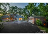 Charming home featuring a stone chimney, inviting front yard and detached garage at 4749 16Th Street Ne Dr, Hickory, NC 28601