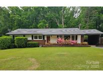 Charming single-story home with brick accents, mature landscaping, and an attached carport at 622 Sedgefield Sw St, Concord, NC 28025