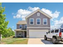 Charming two-story home with attached two-car garage, manicured lawn, and inviting curb appeal at 804 Yorkshire Dr, Albemarle, NC 28001