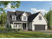 Charming two-story home featuring a covered porch, board and batten siding, and a two-car garage at 120 Starboard Ln # 1, Statesville, NC 28677