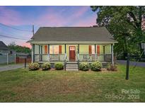 Charming single-story home featuring a welcoming front porch and landscaped front yard at 139 5Th St, Huntersville, NC 28078
