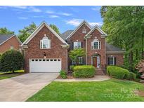 Charming brick home with attached garage and manicured lawn, perfect for families at 202 Whitmyre Ct, Fort Mill, SC 29715