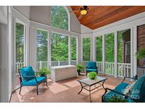 Inviting sun room with expansive windows, tile floor, and ample seating for relaxation at 202 Whitmyre Ct, Fort Mill, SC 29715