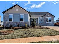 Charming home featuring stone accents, light blue siding, and a well-manicured lawn at 2078 Fordhill St, Rock Hill, SC 29732