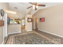 Open-concept living room showcases wood-look floors and a seamless transition into the kitchen area at 228 Grayland Rd, Mooresville, NC 28115