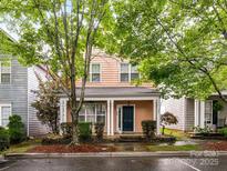 Charming two-story home with a welcoming front porch and well-manicured landscaping at 240 Faust Rd, Davidson, NC 28036