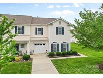 Charming two-story townhome with well-manicured lawn, attached garage, and inviting curb appeal at 3030 Priory Ridge Dr, Fort Mill, SC 29707