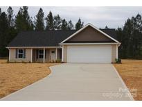 Charming single-story home features a two-car garage, concrete driveway, and newly landscaped yard at 4304 Fletcher Funderburk Rd, Lancaster, SC 29720