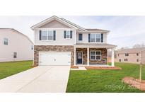 Charming two-story home featuring stone accents, white siding, a two-car garage, and a well-manicured lawn at 4615 Harris Elliot Rd, Lincolnton, NC 28092