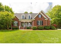 Charming brick home with a manicured lawn, covered porch, and well-maintained landscaping offers great curb appeal at 728 Palmers Pl, Rock Hill, SC 29730