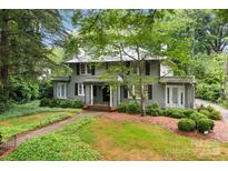 Charming two-story home with a beautifully landscaped front yard and mature trees at 920 Queens Rd, Charlotte, NC 28207