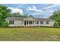 Charming ranch-style home with a welcoming porch, beautiful lawn, and lovely landscaping at 1774 Wintertide Rd, Jefferson, SC 29718