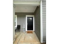 Charming front entrance featuring a black door and a welcoming mat at 205 E Maine Ave, Bessemer City, NC 28016