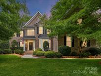 Charming two-story brick home with lush landscaping and an inviting entrance at 3203 Blackburn Dr, Waxhaw, NC 28173