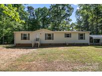 Charming single-story home featuring vinyl siding, green shutters, and a well-maintained front yard at 3317 Treyburn Dr, Midland, NC 28107
