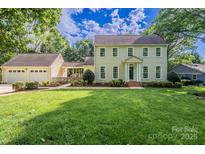 Charming two-story home with an attached two-car garage and a lush green front lawn at 4501 Bainview Dr, Mint Hill, NC 28227