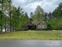 Charming single-story home featuring a landscaped yard, mature trees, and inviting curb appeal at 4561 N Wynswept N Dr, Maiden, NC 28650
