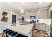 Modern kitchen with stainless steel appliances, granite countertops and a center island with seating at 6266 Tea Olive Dr # 238, Harrisburg, NC 28075