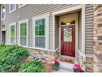 Inviting front entrance with a charming wreath and colorful flower pots at 6842 Berewick Commons Pkwy, Charlotte, NC 28278