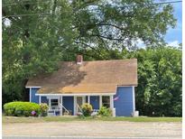 Charming blue single story home with front porch and decorative yard at 745 Old Charlotte Sw Rd, Concord, NC 28027