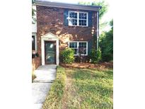 Charming brick two-story home featuring green shutters and well-maintained front yard at 8835 Hunter Ridge Dr, Charlotte, NC 28226