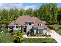 Beautiful gray two-story home featuring a manicured front lawn, stone accents, and a symmetrical facade at 1149 Grand Oak Dr, Waxhaw, NC 28173