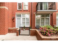 Charming brick patio with a small garden and a metal railing entrance, offering a cozy outdoor space at 1320 Fillmore Ave # 112, Charlotte, NC 28203