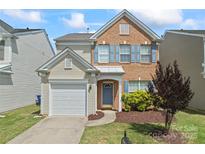 Charming two-story home with brick and vinyl siding, attached garage, and manicured lawn at 15009 Medlock Ln, Charlotte, NC 28277