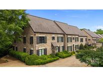 Stately stone townhome with manicured landscaping and private driveway at 1550 High St, Charlotte, NC 28211