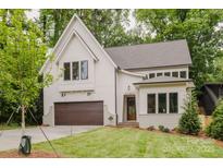 Beautiful two-story home featuring a modern design, attached garage, and professionally landscaped front yard at 1807 Arnold Dr, Charlotte, NC 28205