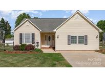 Charming ranch-style home with a well-manicured lawn and inviting front entrance at 206 Summey Barker Dr, Dallas, NC 28034
