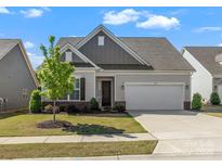 Charming single-story home with a two-car garage, manicured lawn and attractive landscaping, located in a desirable community at 329 Brambling Ct, Monroe, NC 28110