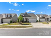 Charming single-Gathering home with well-maintained lawn, inviting curb appeal, and attached two car garage at 329 Brambling Ct, Wesley Chapel, NC 28110