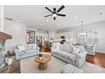 Spacious living area showcasing a modern kitchen, cozy seating, and abundant natural light at 329 Brambling Ct, Monroe, NC 28110
