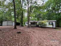 Charming single-story home with white siding, metal roof, and spacious front yard surrounded by mature trees at 351 Fletcher Rd, Union Grove, NC 28689