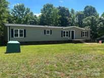 Charming home with green siding, black shutters, and a well-manicured lawn at 353 Quail Pointe Dr, Salisbury, NC 28147