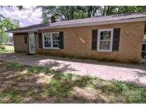 Charming one-story brick home with classic window shutters and welcoming front entrance at 515 Upper Spencer Mountain Rd, Stanley, NC 28164