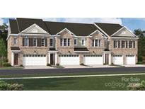 Beautiful brick townhome featuring a front-entry garage and multiple windows for ample natural light at 12033 Lavinia Ln, Charlotte, NC 28277