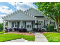 Charming single-story home with a covered front porch and well-manicured landscaping at 13360 Old Compton Ct, Pineville, NC 28134