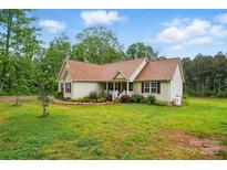 Charming single-story home featuring a manicured lawn, lovely landscaping, and classic curb appeal at 1534 Buffalo Shoals Rd, Lincolnton, NC 28092