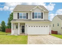 Charming two-story home featuring a two-car garage and covered front porch at 217 Almora Loop, Mooresville, NC 28115