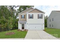 Charming two-story home features a well-manicured lawn and attached two car garage at 414 Janie Nw Cir, Newton, NC 28658