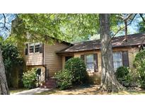 Charming two-story home featuring a brick facade and lush landscaping at 425 Roselawn Pl, Charlotte, NC 28211