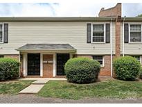 Charming townhouse exterior with well-maintained landscaping, brick accents, and neutral siding at 4609 Coronado Dr, Charlotte, NC 28212
