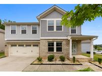 Charming two-story home featuring a brick facade, attached garage, and well-manicured landscaping at 614 Oldham Ln, Rock Hill, SC 29732