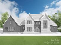 Stunning new construction home features a classic brick facade, elegant arched entry, and a beautifully manicured lawn at Lot 5 Holbrook Rd # 5, Fort Mill, SC 29715