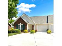Charming single-story home with a brick facade, attached garage, and well-manicured landscaping, offering great curb appeal at 101 Keswick Ln, Mooresville, NC 28117