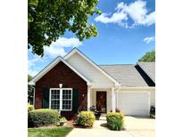 Charming single-story home with brick accents, green shutters, and a well-manicured lawn on a sunny day at 101 Keswick Ln, Mooresville, NC 28117