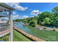 Picturesque waterfront view with docks and lush greenery under a sunny sky at 104 Pier 33 Dr # 312, Mooresville, NC 28117