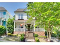 Charming two-story home featuring a welcoming front porch and well-manicured landscaping at 117 Mills Ln, Fort Mill, SC 29708